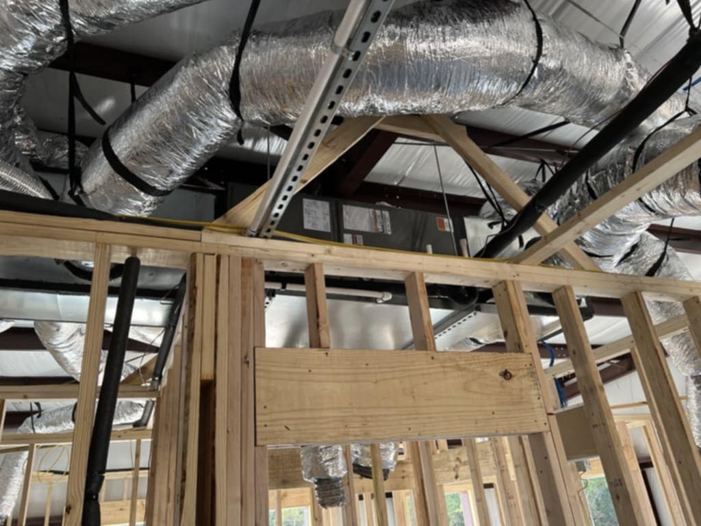 New flexible ductwork run through open ceiling framing